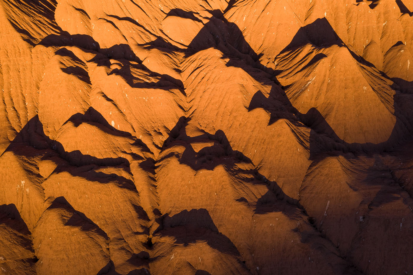 I used the aerial perspective to expand the distances between these interlacing hills and their shadows at sundown. 