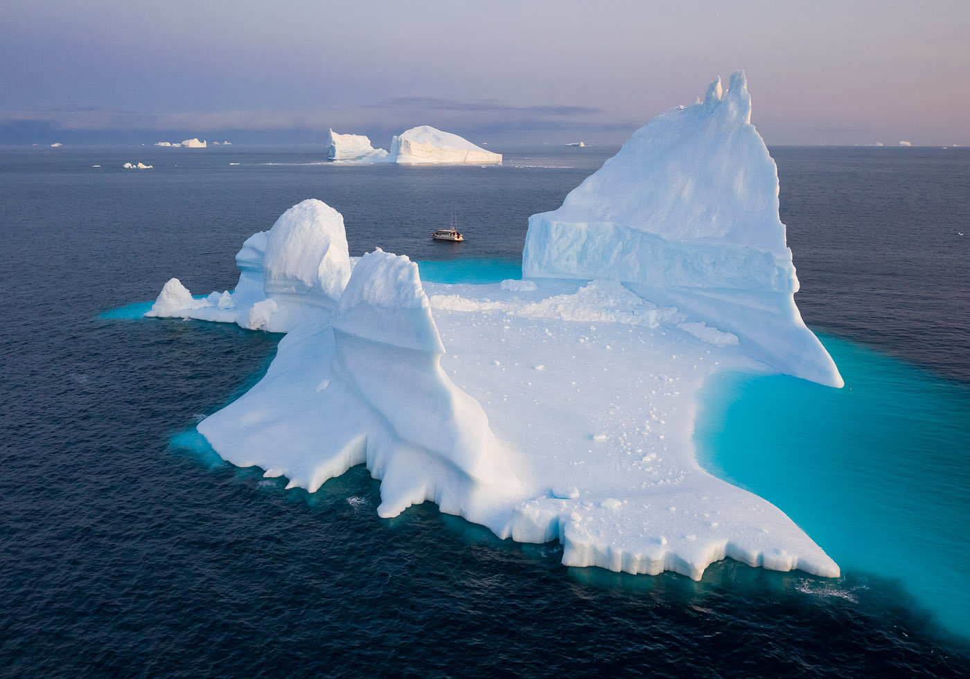 My drone lost connection for a few moments when this iceberg's peaks came between it and the moving boat. There was little to worry about, however, as I knew connection would be regained in a matter of seconds. DJI Mavic II Pro, 1/30 sec, f/5.6, ISO 200. Disko Bay, Greenland.