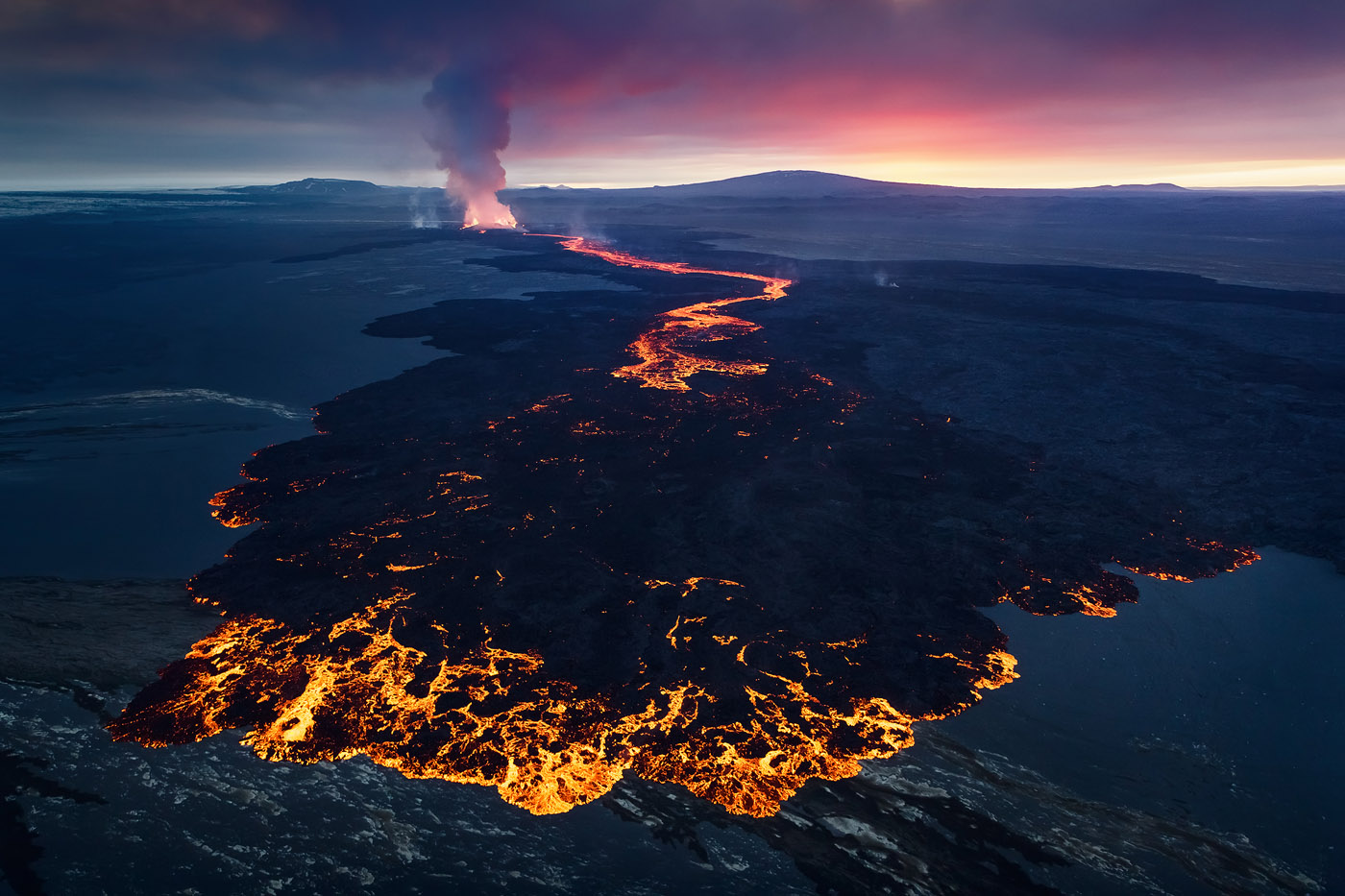 When shooting the 2014 Holuhraun volcanic eruption from a helicopter, I spent more than an hour shooting a mind-blowing sunset over the lava, and stayed well into darkness. A drone wouldn't have been able to remain airborne for long enough to get these conditions (not to mention get there!).<br />Canon 5D Mark II, Tamron 24-70mm F2.8 VC, 1/200 sec, f/4, ISO 1600. The Central Highlands of Iceland