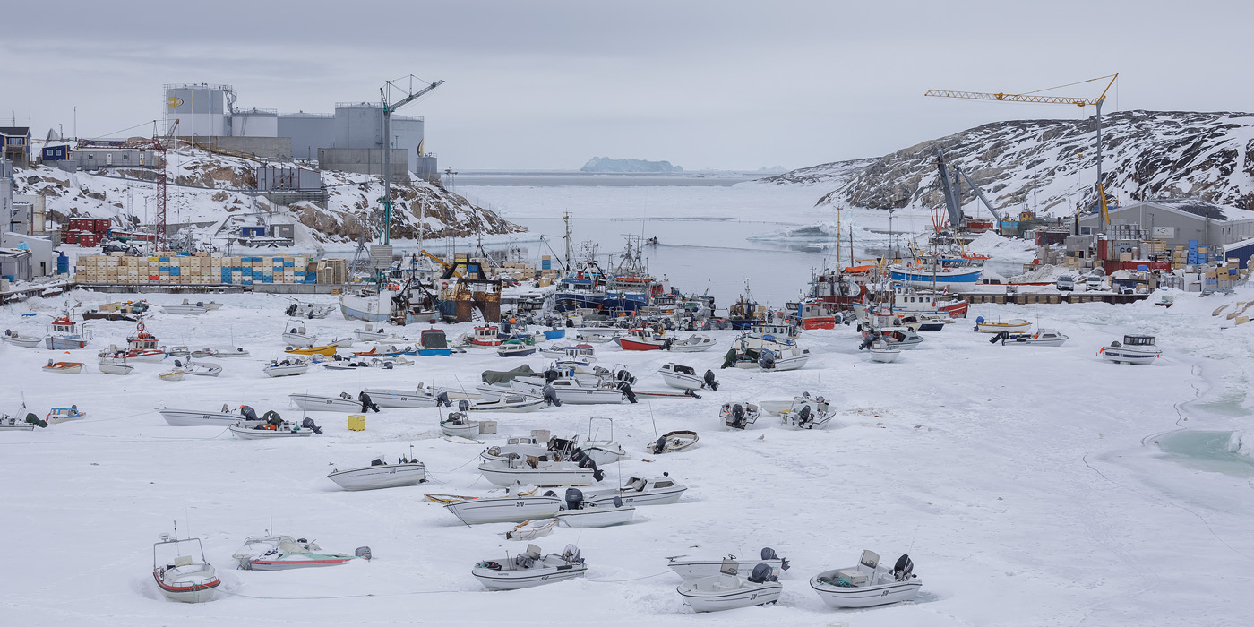 Ilulissat harbor in winter. The boats are resting on sea ice.