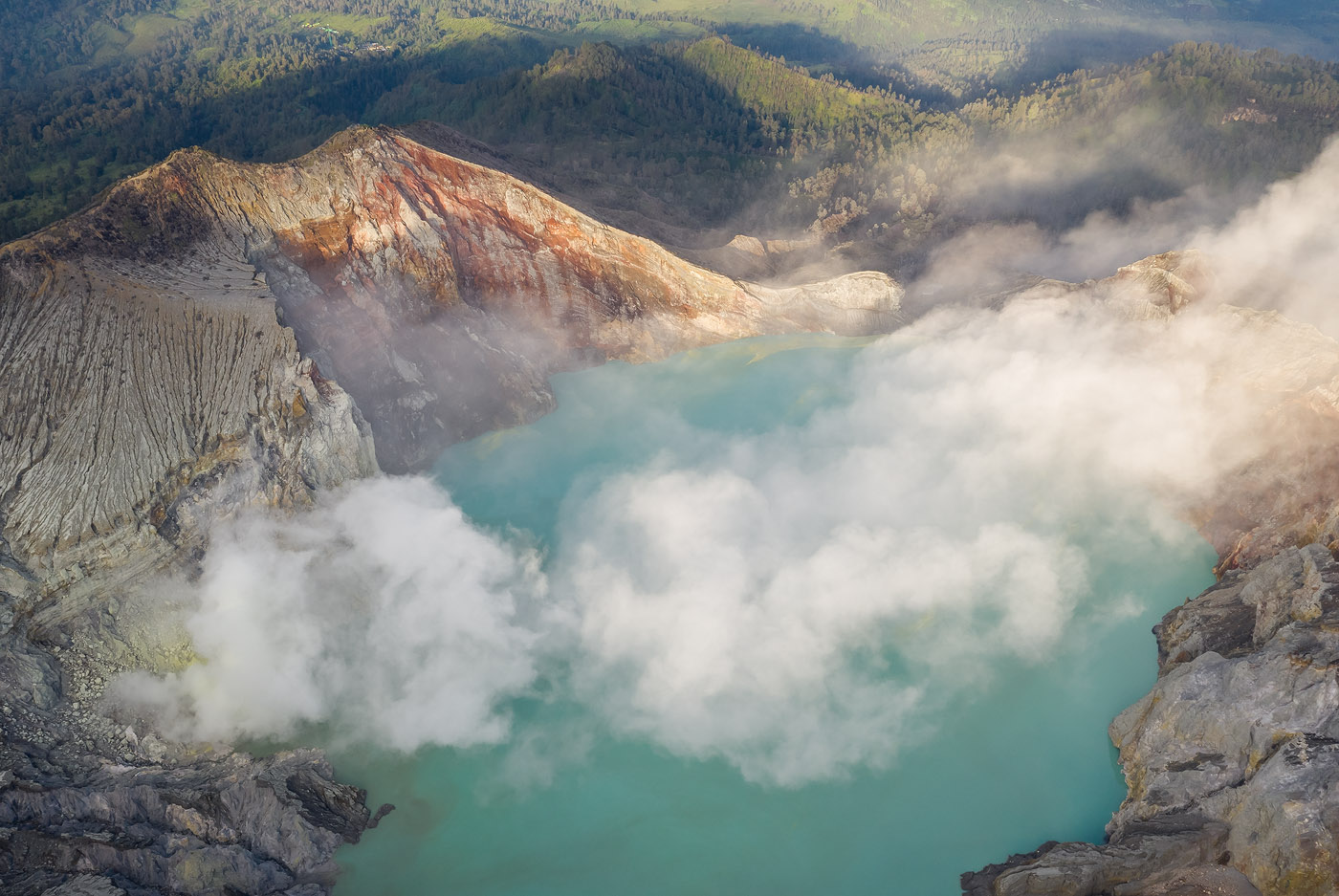 In this aerial I used layering as a compositional tool. Notice how the layers of smoke/lake/bare mountain/ lush forest, together with light and shadow, create both depth and continuity, and tell a story of natural contrasts.