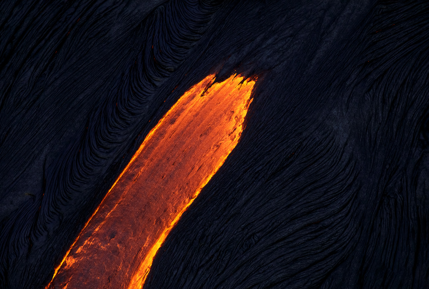 The lava surface flows look like painted brush-strokes on the dark earth