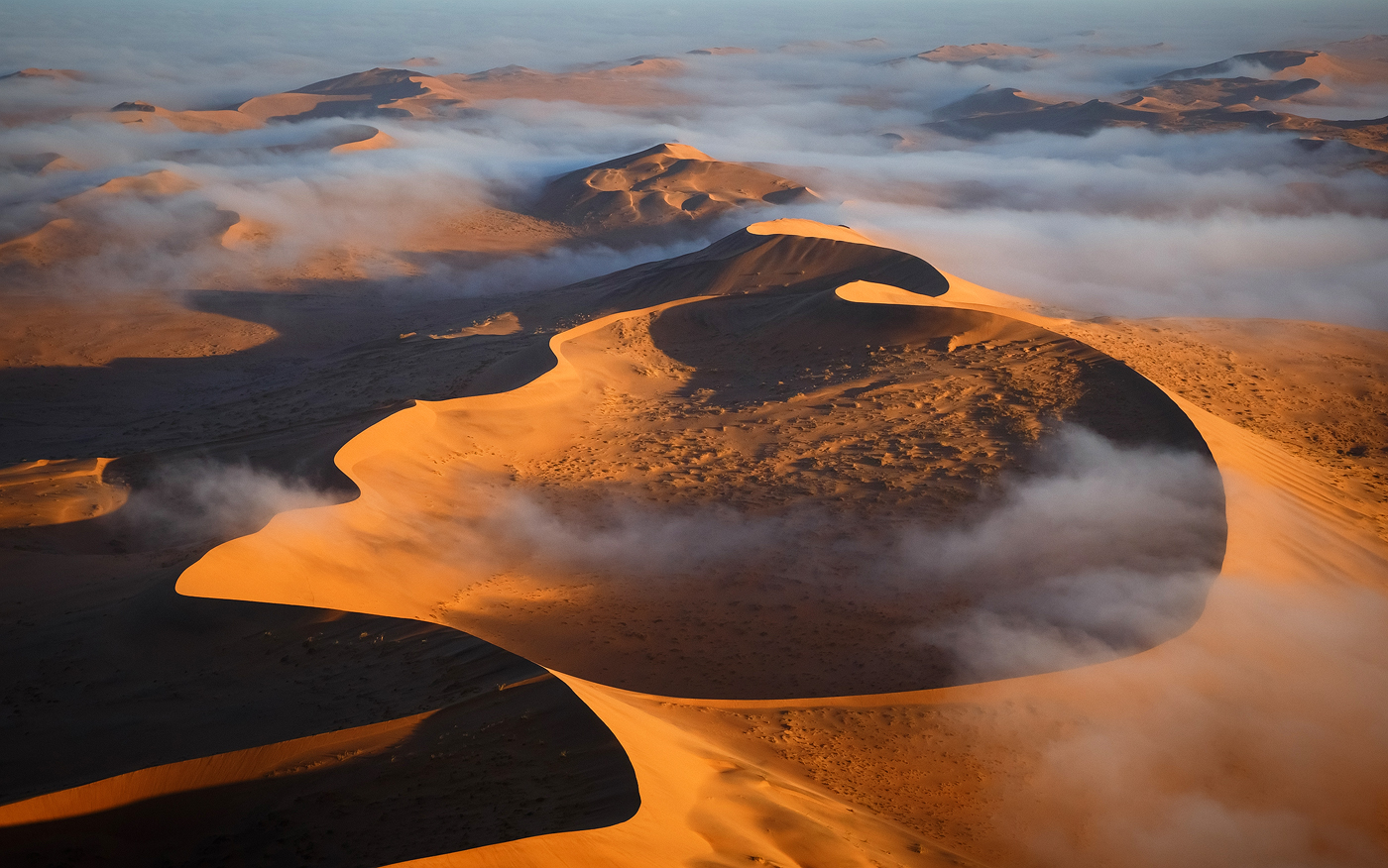 The gigantic dunes of the Namib Desert can rise 300 meters high – no chance of shooting them with a drone, even if droning were allowed in the accessible parts of Sossusvlei, which it isn't. I took this image from a helicopter at a height of more than a kilometer in the air. </br>Canon 5D Mark III, Tamron 24-70 f/2.8 VC, 1/1250 sec, F10, ISO 800. Sossusvlei, Namibia