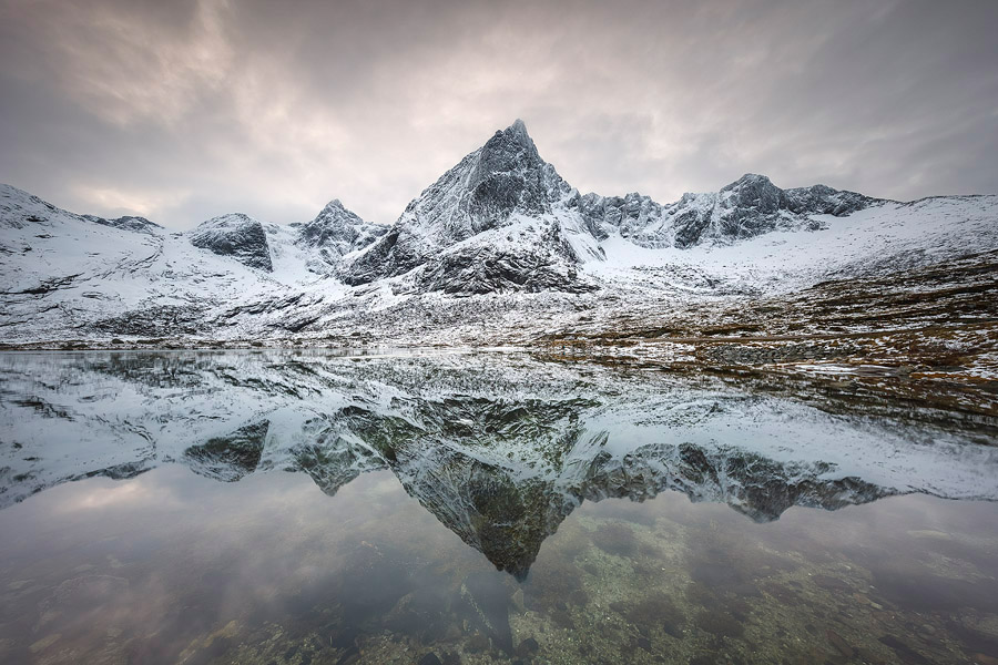 Mount Stortinden reflecting in the calm Flakstad Fjord, Lofoten. I was standing about 1 km from this 850m tall mountain. Being so close, I couldn't have included both the mountain and the reflection with a 16mm. It was easily done, however, with the 11-24mm.<br>Canon EOS 5D Mark IV, Canon 11-24mm F4L, Nisi Filters 180mm ND+GND, 11mm, F11, 0.5 sec, ISO100