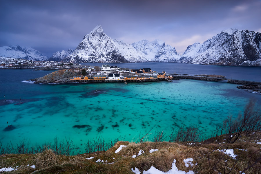 Mount Olstind above the orange cabins and turquise waters of Sakrisøy