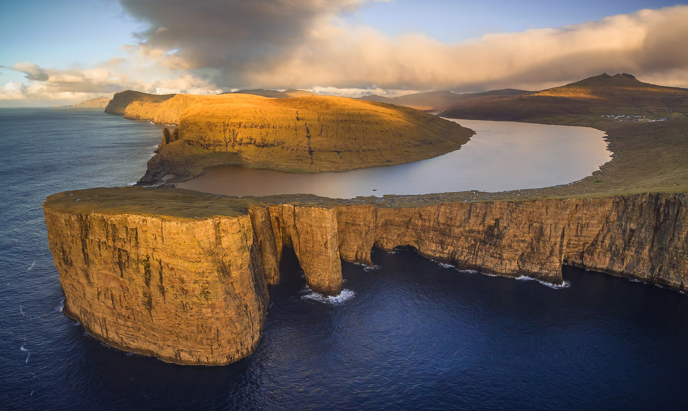 High Above Sørvágsvatn The incredible Lake Sørvágsvatn and surrounding cliffs, bathed in warm